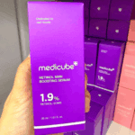 Medicube Retinol NMN Boosting Serum 1.9% packaging box held in hand inside skincare store