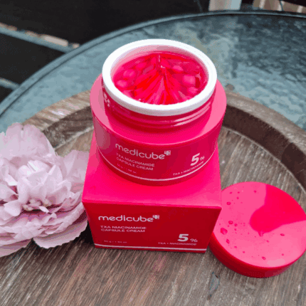 Open Medicube TXA Niacinamide Capsule Cream showing pink capsule texture inside jar