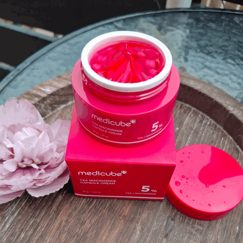 Open Medicube TXA Niacinamide Capsule Cream showing pink capsule texture inside jar
