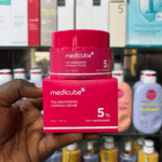 Medicube TXA Niacinamide Capsule Cream 5% jar placed on box with store background