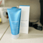 Medicube Zero Foam Cleanser tube placed in front of its box on a countertop indoors