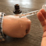 Dropper applying The Ordinary Moroccan Argan Oil onto skin showing lightweight oil texture