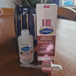 Open Cetaphil Healthy Radiance Brightening Serum bottle with dropper and product box on table