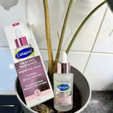 cetaphil Healthy Radiance Brightening Serum bottle and box placed in plant pot lifestyle setting
