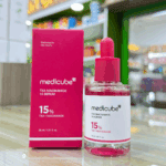 Medicube TXA Niacinamide 15 Serum bottle displayed next to original packaging box