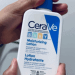 Hand holding CeraVe Baby Moisturizing Lotion 473ml bottle, fragrance free baby lotion with ceramides developed by pediatric dermatologists available in Sri Lanka