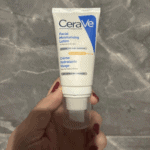Hand holding CeraVe Facial Moisturising Lotion AM SPF 50 tube, daily face moisturizer for normal to dry skin with broad spectrum UV protection available in Sri Lanka