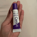 Hand holding CeraVe Skin Renewing Eye Cream 15ml tube, peptide complex under eye cream developed by dermatologists available in Sri Lanka