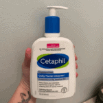 Hand holding Cetaphil Daily Facial Cleanser 473ml pump bottle fragrance free gentle face wash for oily and sensitive skin Sri Lanka