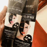 Hand holding Dr Rashel Black Peel Off Mask 120ml tube with box, charcoal collagen peel off face mask for blackhead removal and deep pore cleansing available in Sri Lanka