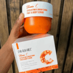 Dr Rashel Vitamin C exfoliating and brightening face and body scrub 250ml held with product box in Sri Lanka