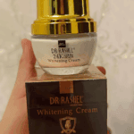 Hand holding Dr Rashel Whitening Cream 24K Gold Collagen 30ml jar with box, gold collagen brightening face cream for radiant skin available in Sri Lanka