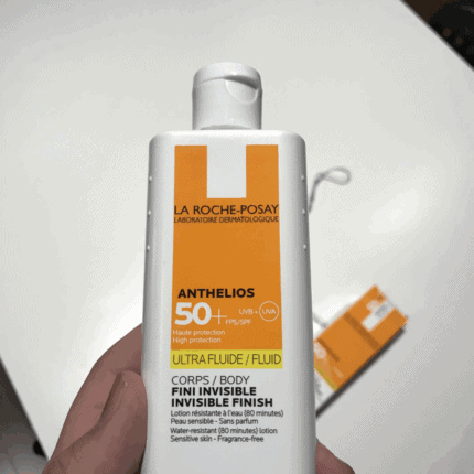 La Roche-Posay Anthelios Ultra Fluid SPF 50 125ml body sunscreen bottle held in hand, showing invisible finish formula with high UVA and UVB protection.