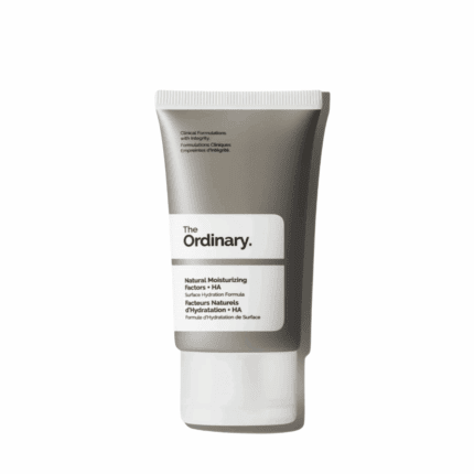 The Ordinary Natural Moisturizing Factors + HA 30ml moisturizer in a grey squeeze tube with a white label and cap against a soft yellow background.
