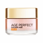 Open jar of Age Perfect Golden Age SPF 20 anti-aging face cream showing smooth creamy texture inside a pink glass container with branding visible on a clean background