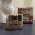 L’Oréal Paris Age Perfect Golden Age SPF 20 face cream jar with gold lid placed on a surface alongside its product box in the background, showcasing anti-aging skincare packaging and design