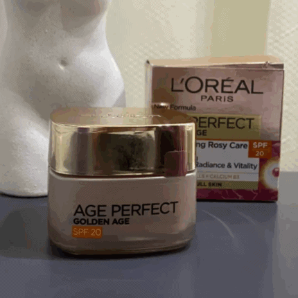 L’Oréal Paris Age Perfect Golden Age SPF 20 face cream jar with gold lid placed on a surface alongside its product box in the background, showcasing anti-aging skincare packaging and design