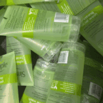 Multiple Simple Refreshing Facial Wash gel tubes showing back labels with ingredients and product details, stacked together to display packaging information in bulk