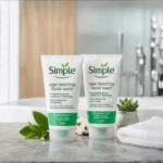 “Two Simple Age Resisting Facial Wash tubes on bathroom counter with plants and towel, gentle hydrating cleanser for sensitive skin, 150 ml”